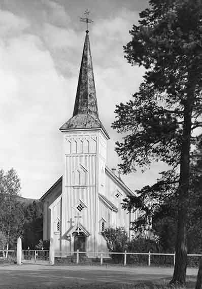 Front Of Heritage Church With Large Tall Steeple With Weather Vane European Countryside Trees White Fence