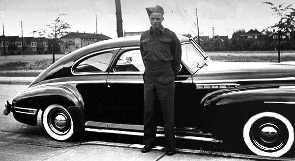 Young Military Serviceman Standing Next To Brand New 1941 Buick Special Sedanette Car Model 46S Fastback