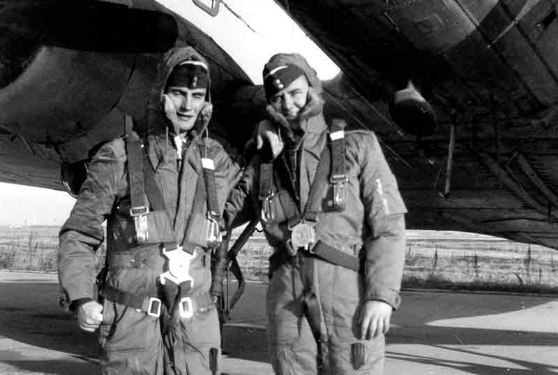 Two Air Force Pilots Standing Under Belly Of Large Prop Airplane Arms Around Each Other 1940's